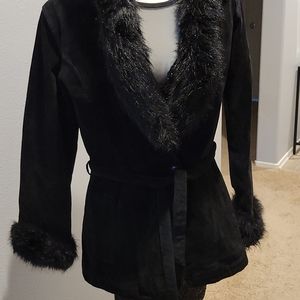 Suede jacket with hood and fur trimming.